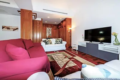 a living room with a purple couch and a tv at E&L apt 150sqm 3BR Metro 30m Park in Rome