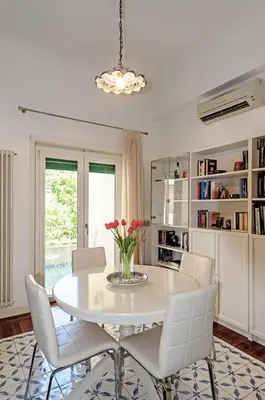 a white dining room with a white table and chairs at E&L apt 150sqm 3BR Metro 30m Park in Rome