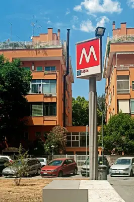 a sign on a pole with cars parked in a parking lot at E&L apt 150sqm 3BR Metro 30m Park in Rome