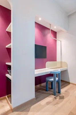 a table and bench in a room with a purple wall at UNICO Suite - GRUPPO BLAM in Rome