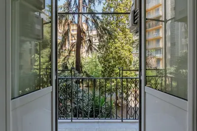 an open door to a balcony with a tree at UNICO Suite - GRUPPO BLAM in Rome