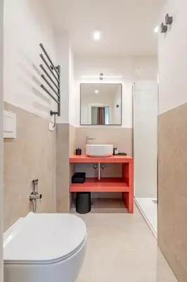 a bathroom with a toilet and a sink and a mirror at UNICO Suite - GRUPPO BLAM in Rome