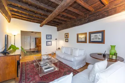 a living room with a white couch and a table at Santa Margherita by Rental in Rome in Rome