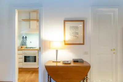 a kitchen with a table with a lamp on it at Santa Margherita by Rental in Rome in Rome