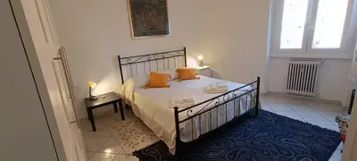 a bedroom with a bed with orange pillows on it at Urban Welcome Metro Battistini in Rome
