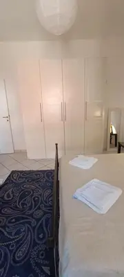 a bedroom with a bed with white cabinets at Urban Welcome Metro Battistini in Rome