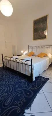 a bedroom with two beds and a blue rug at Urban Welcome Metro Battistini in Rome