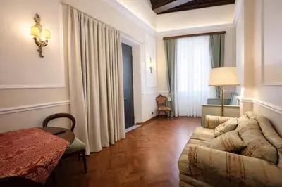 a living room with a couch and a bed at Veronica Suite, Historic Centre Piazza Venezia in Rome