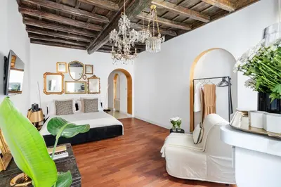 a bedroom with a bed and a living room at JSuite in Rome