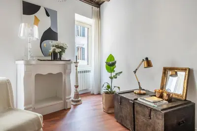 a living room with a table and a fireplace at JSuite in Rome