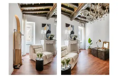 a living room with white furniture and a chandelier at JSuite in Rome