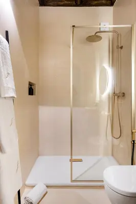 a shower with a glass door in a bathroom at JSuite in Rome