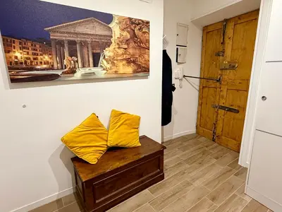 a room with a bench with two yellow pillows on it at Rosetta Lovely House - Pantheon - Roma in Rome