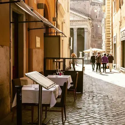 a restaurant with a table and chairs in a street at Rosetta Lovely House - Pantheon - Roma in Rome