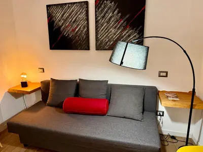 a living room with a couch with a red pillow at Rosetta Lovely House - Pantheon - Roma in Rome