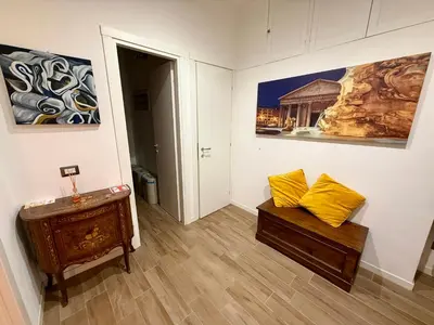 a room with a bench and paintings on the wall at Rosetta Lovely House - Pantheon - Roma in Rome