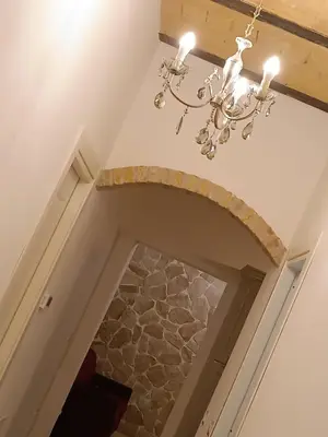 a chandelier hanging from a ceiling in a hallway at Testaccio Charme Apt in Rome