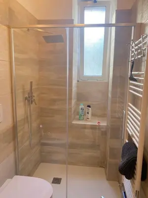 a shower with a glass door in a bathroom at Testaccio Charme Apt in Rome