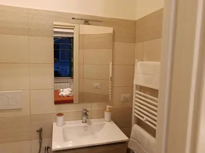 a bathroom with a sink and a mirror at Testaccio Charme Apt in Rome