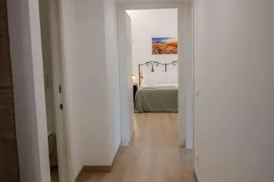 a hallway leading to a bedroom with a bed at Fiqus in Rome