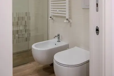 a bathroom with a toilet and a sink at Fiqus in Rome