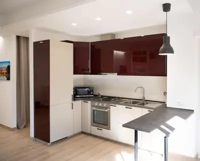 a kitchen with white cabinets and a counter top at Fiqus in Rome