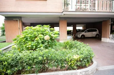 a car parked in a parking lot in front of a building at Fiqus in Rome