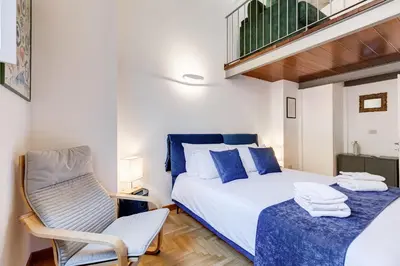 a small bedroom with a bed and a chair at Casa Valentina - Oasi di tranquillità e stile a Testaccio in Rome