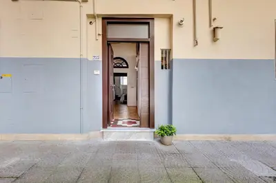 a door to a building with a potted plant at Casa Valentina - Oasi di tranquillità e stile a Testaccio in Rome