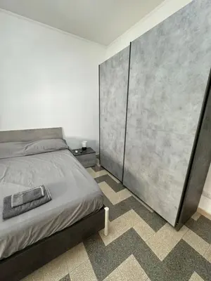 a bedroom with a bed and a large concrete wall at Silihome, Trastevere, Piazza della Radio in Rome