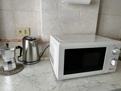 a microwave oven sitting on a counter with a blender at Silihome, Trastevere, Piazza della Radio in Rome