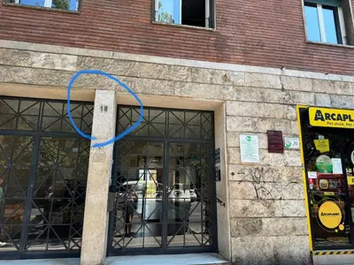 a blue ribbon is hanging outside of a building at Silihome, Trastevere, Piazza della Radio in Rome