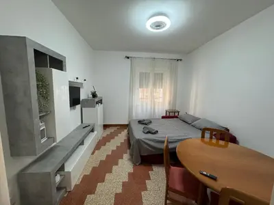 a bedroom with a bed and a table and a dining room at Silihome, Trastevere, Piazza della Radio in Rome