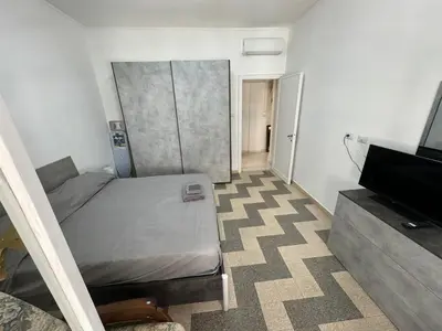 a small bedroom with a bed and a television at Silihome, Trastevere, Piazza della Radio in Rome