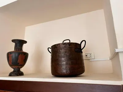 two vases are sitting on a shelf at DOMUS Laura VATICANO in Rome