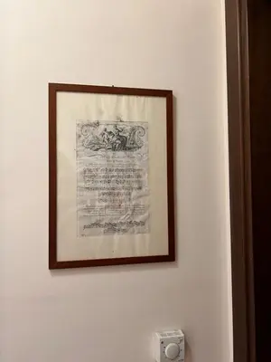 a picture hanging on a white wall with a picture at DOMUS Laura VATICANO in Rome