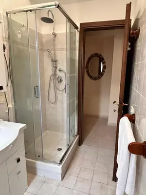 a bathroom with a shower with a glass shower stall at DOMUS Laura VATICANO in Rome