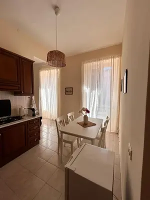 a kitchen and dining room with a table and chairs at DOMUS Laura VATICANO in Rome