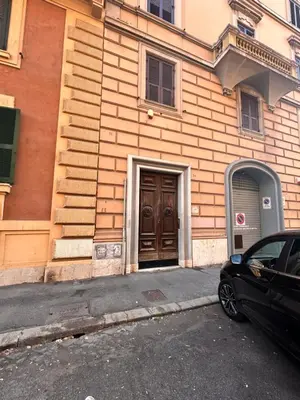 a building with a door and a car parked in front at DOMUS Laura VATICANO in Rome