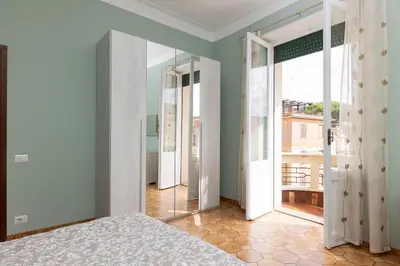 a bedroom with a bed and a large window at VIVA Rome Apartment 