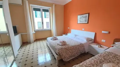 a bedroom with two beds and orange walls at VIVA Rome Apartment 