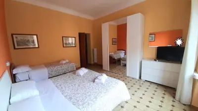 a hotel room with two beds and a television at VIVA Rome Apartment 