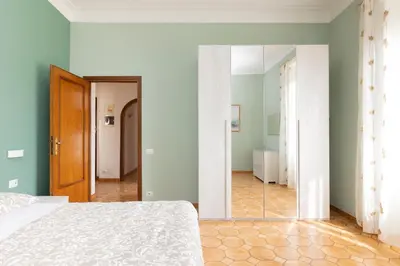 a bedroom with a bed and a mirror at VIVA Rome Apartment 