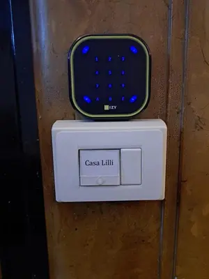 a cell phone sitting on top of a cash limit box at Casa Lilli in Rome