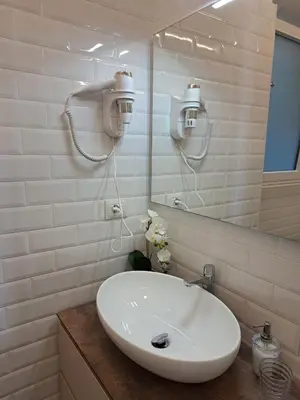a bathroom with a white sink and a mirror at Casa Lilli in Rome