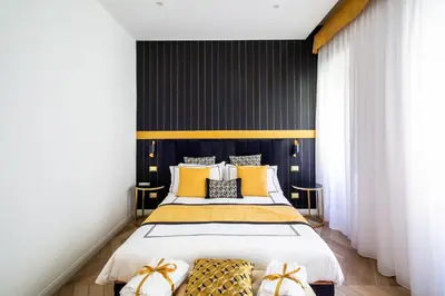 a bedroom with a bed with yellow and black walls at Mazzini City Center Apartment - Vaticano - Foro Italico - Stadio Olimpico-Rai Delle Vittorie in Rome