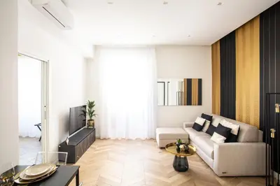 a living room with a couch and a table at Mazzini City Center Apartment - Vaticano - Foro Italico - Stadio Olimpico-Rai Delle Vittorie in Rome
