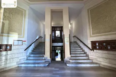 a stairway in a building with stairs leading to doors at Mazzini City Center Apartment - Vaticano - Foro Italico - Stadio Olimpico-Rai Delle Vittorie in Rome