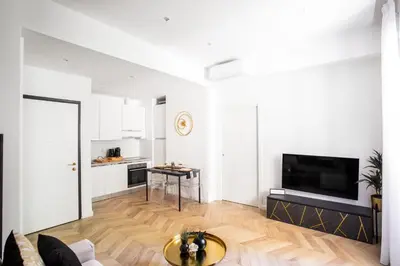 a living room with a couch and a tv at Mazzini City Center Apartment - Vaticano - Foro Italico - Stadio Olimpico-Rai Delle Vittorie in Rome