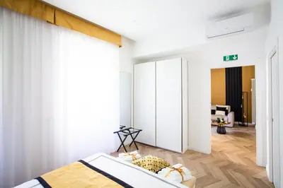 a bedroom with a bed and a living room at Mazzini City Center Apartment - Vaticano - Foro Italico - Stadio Olimpico-Rai Delle Vittorie in Rome